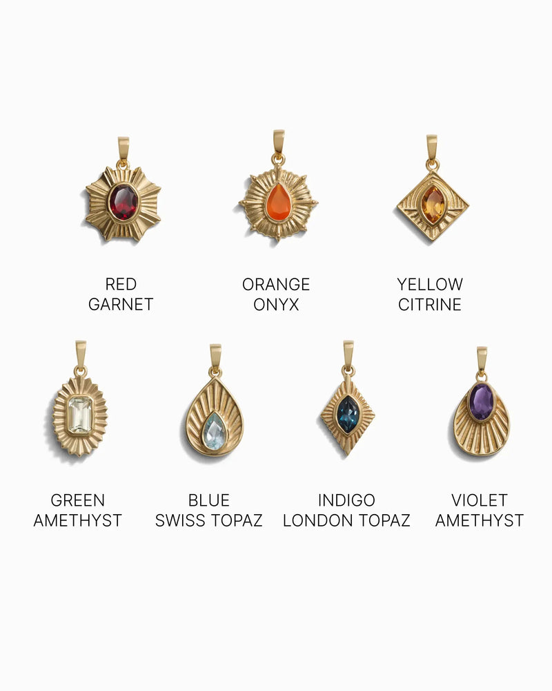 Seven gold pendants featuring an array of gemstones—red garnet, orange onyx, yellow citrine, green amethyst, blue Swiss topaz, indigo London topaz, and violet amethyst—arranged in two rows. Ideal for the Chakra Pendant set or to enhance your Awe Inspired Invisible Aura Charm Bracelet.