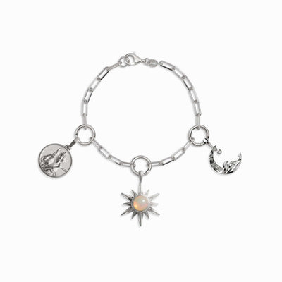 Awe Inspired's Cosmic Euphoria Charm Bracelet features three charms: a silver circle with a horse, an opal sun radiating cosmic euphoria at the center, and a crescent moon adorned with a woman.