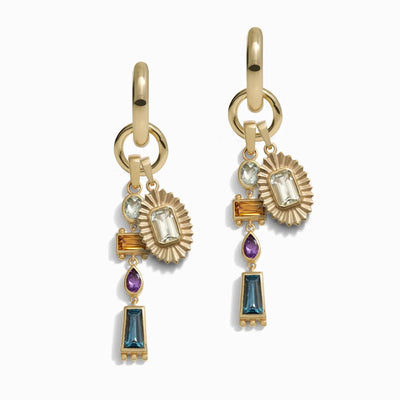 Introducing the Natural Aura Charm Earrings from Awe Inspired, a pair of gold hoop earrings embellished with an array of gemstones in various shapes and hues. Featuring London blue topaz, purple amethyst, light green amethyst, and amber stones, the design incorporates geometric and sunburst elements to create an enchanting Earth Goddess Talisman.