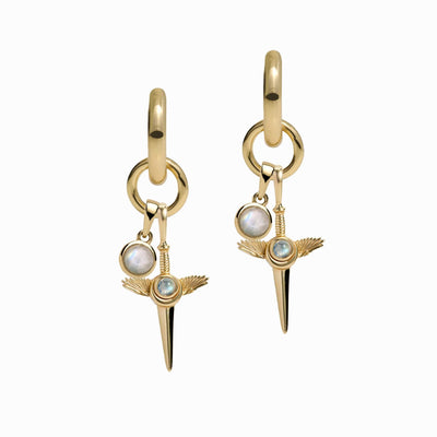 Introducing the Blood Moon Rising Charm Earrings by Awe Inspired: a stunning pair of gold hoop earrings boasting dangling pendants with round white gemstones, a smaller blue gem, and intricate gold winged spike designs—ideal for any Charm Collector Earring enthusiast.