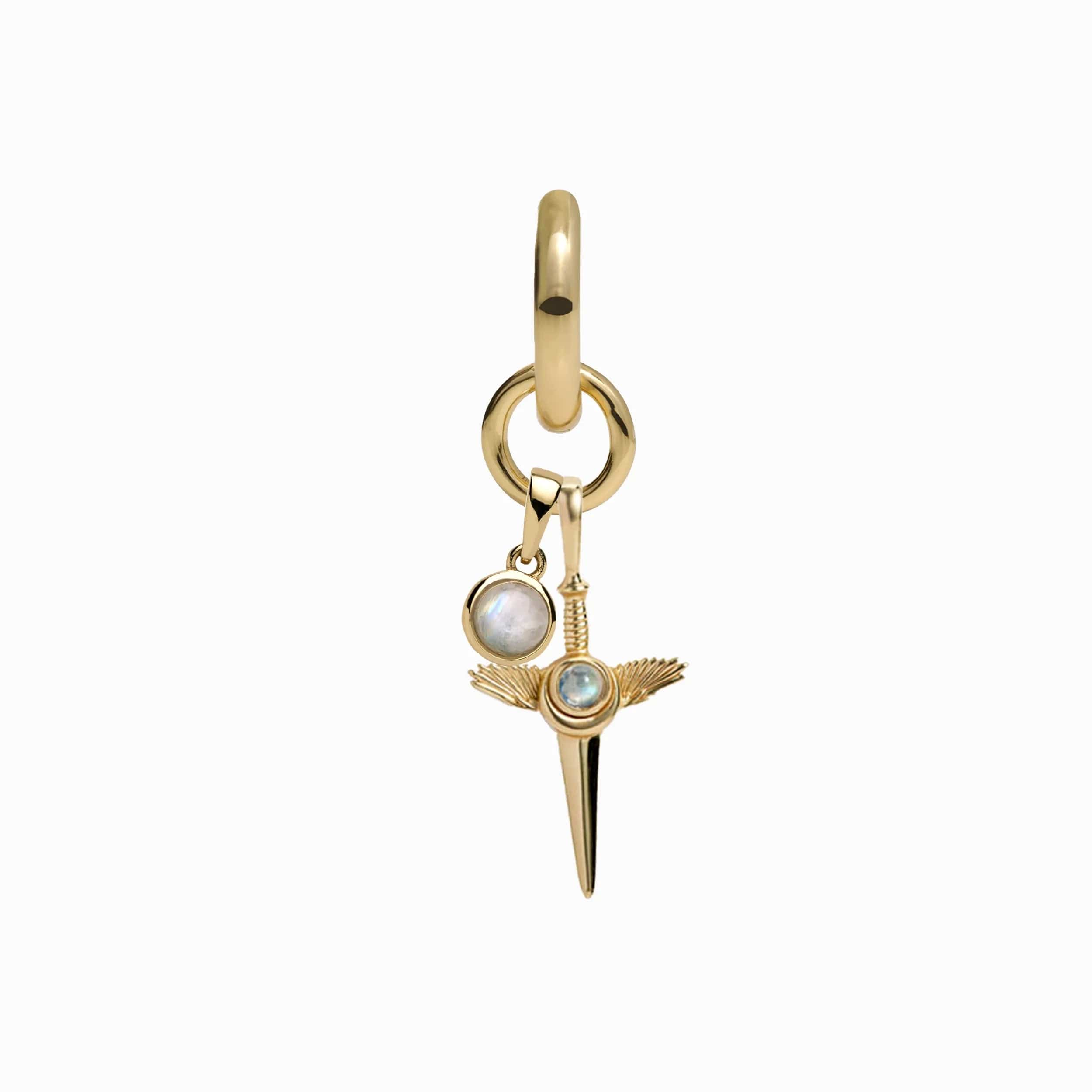 The Blood Moon Rising Charm Earrings by Awe Inspired feature a gold pendant with spike and winged details, as well as a smaller rainbow moonstone amulet adorned with a circular gemstone.