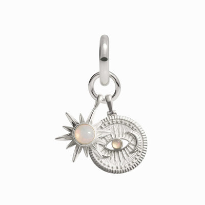 The Psychic Awakening Charm Earring by Awe Inspired features a silver charm with a sunburst design, showcasing a circular opal, and is accompanied by a textured round disc adorned with an eye motif and an additional opal. This exquisite piece is perfect for any collector seeking mystical elegance.