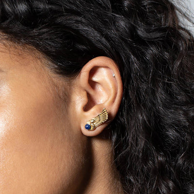Close-up of a person wearing the Winged Cobra Lapis Lazuli Stud by Awe Inspired.