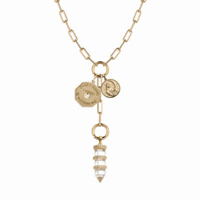 The Manifestation Charm Lariat by Awe Inspired features a gold chain with two "Everything I Need Is Within Me" coin pendants and a central dangling crystal pendant, symbolizing abundance.