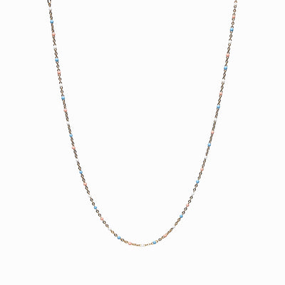 A delicate Trans Pride Beaded Enamel Necklace by Awe Inspired with small blue beads evenly spaced along the length of the chain.