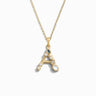 The Gold Gemstone Initial Necklace by Awe Inspired features a gold chain adorned with a pendant shaped like the letter "A," embellished with bezel-set gemstones for extra brilliance. It's perfect for making a statement with its elegantly designed initial charm.