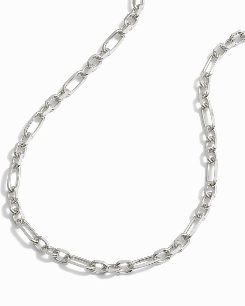 The Statement Chain Necklace by Awe Inspired features elongated oval links arranged in a continuous pattern, making it perfect for a stylish necklace stack.