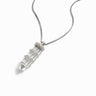 Awe Inspired's Manifestation Crystal Necklace, a silver chain adorned with a pointed clear quartz pendant featuring three silver bands, combines elegance and intention.