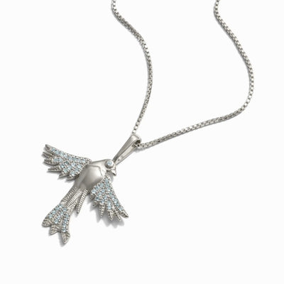 Suffragist Bluebird Necklace by Awe Inspired featuring a bluebird-shaped pendant with blue topaz accents on a silver chain, displayed against a white background.