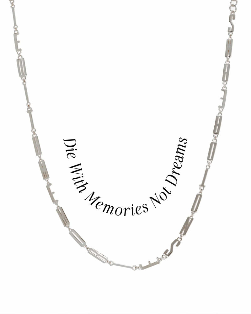 The Men's Affirmation Necklace by Awe Inspired features a rectangular chain with the mantra "Die With Memories Not Dreams" engraved on a silver pendant.