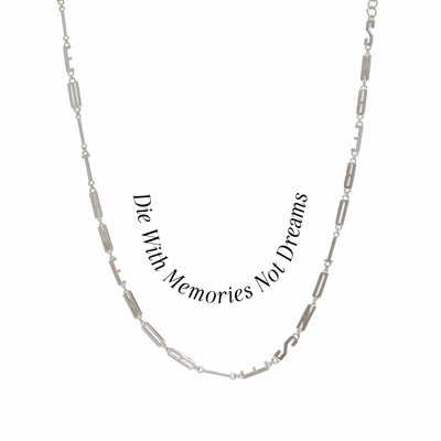 The Men's Affirmation Necklace by Awe Inspired features a rectangular chain with the mantra "Die With Memories Not Dreams" engraved on a silver pendant.