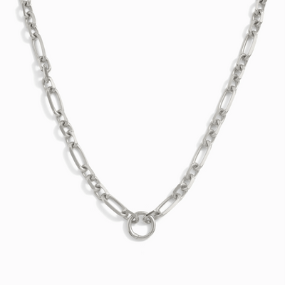 The Statement Single Charm Collector Necklace by Awe Inspired features wide luxe interlocking oval links in a silver chain and a central circular clasp.