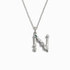 The Silver Gemstone Initial Necklace by Awe Inspired is a beautiful silver necklace featuring a statement-sized pendant shaped like the letter "N" and adorned with bezel-set gemstones.