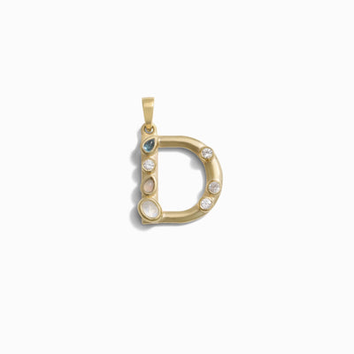 The Gemstone Initial Pendant by Awe Inspired is a gold pendant in the shape of the letter "D," featuring bezel-set gemstones, including diamonds and colored stones. This personalized jewelry piece makes a perfect addition to any collection, blending elegance with a touch of individuality.