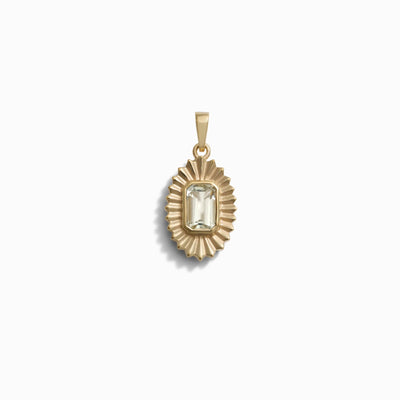 Aura Pendant by Awe Inspired features a gold setting with an emerald-cut clear gemstone, designed in a radiant sunburst pattern to enhance your chakra. Displayed on a white background.