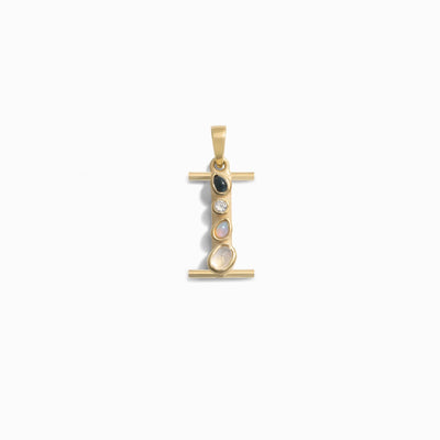 The Gemstone Initial Pendant by Awe Inspired is a gold pendant shaped like the letter "I," featuring four bezel-set gemstones vertically in the center, perfect for those who appreciate personalized jewelry.