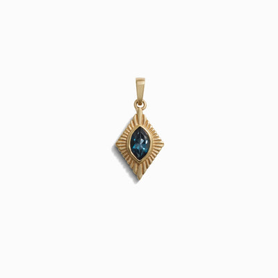 Awe Inspired's Aura Pendant is a stunning gold piece, showcasing a square frame with an intricate starburst pattern and a central blue gemstone that is believed to enhance your aura, all set against a white backdrop.