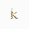 The "Gemstone Initial Pendant" by Awe Inspired, a gold pendant shaped like the letter "K" and adorned with various bezel set gemstones, makes for exquisite personalized jewelry.