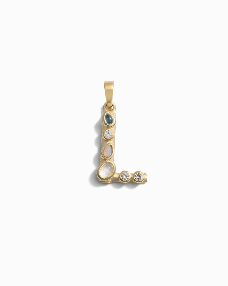 Introducing the Gemstone Initial Pendant by Awe Inspired, a gold pendant in the shape of the letter "L," adorned with bezel-set gemstones of varying colors and sizes, perfect for those who appreciate personalized jewelry.