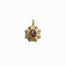 An Aura Pendant by Awe Inspired, featuring a gold star-shaped design with a red gemstone center that radiates a balanced aura.