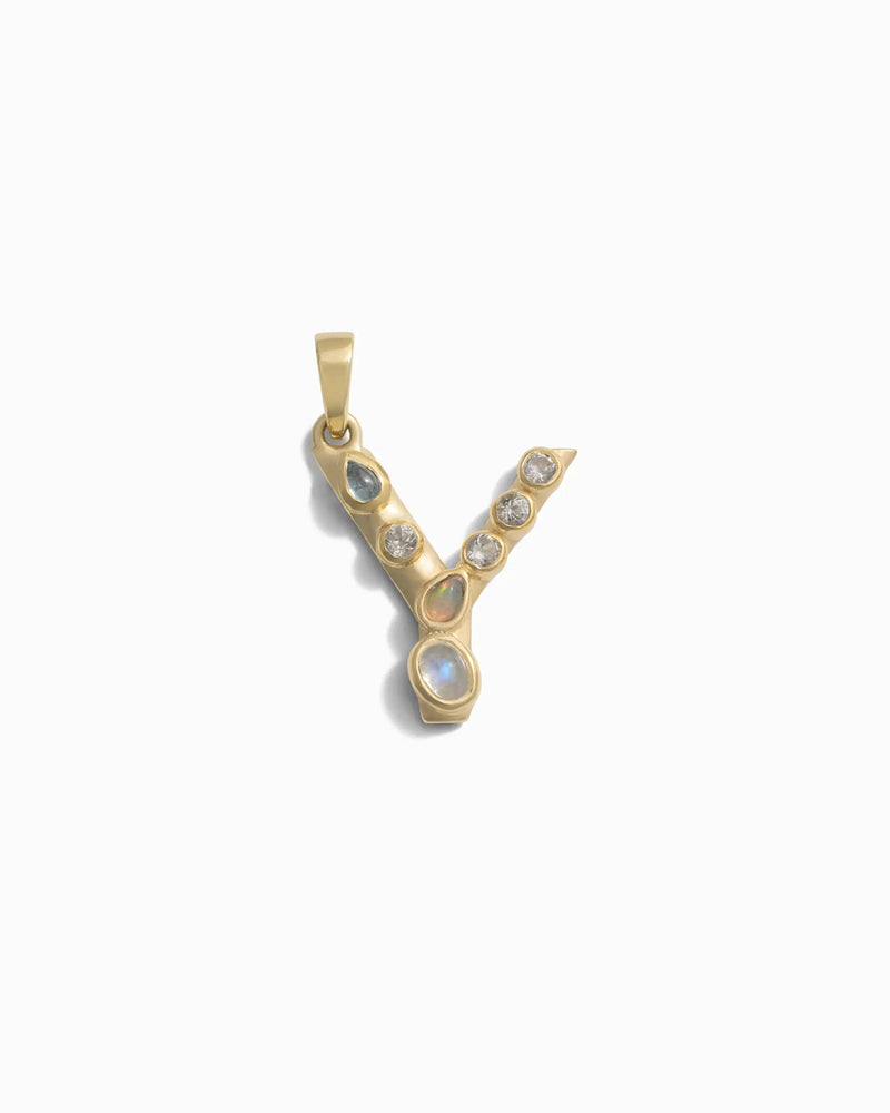 Awe Inspired's Gemstone Initial Pendant, shaped like the letter "Y" and adorned with bezel set gemstones along with a single larger opalescent stone at the bottom, displayed on a white background.