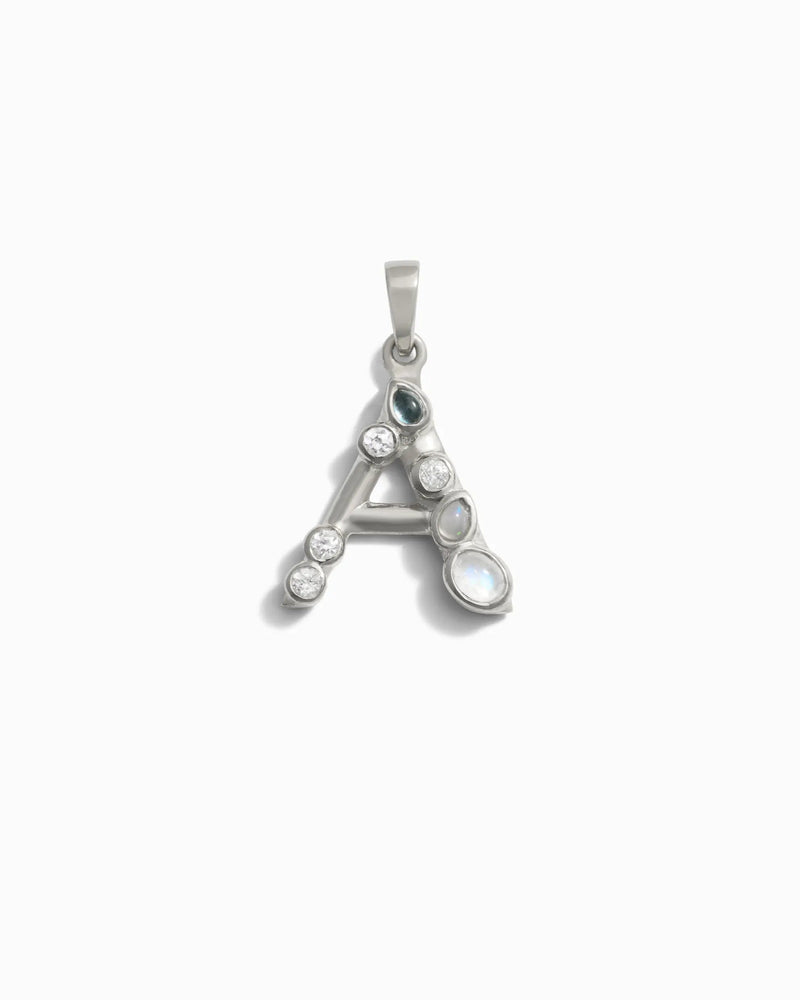 Introducing the "Gemstone Initial Pendant" by Awe Inspired—a captivating silver letter "A" pendant embellished with small bezel set gemstones, complete with a loop at the top for easy attachment to any necklace. This piece makes an excellent choice for personalized jewelry or initial charms.