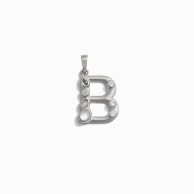 Awe Inspired's Gemstone Initial Pendant features a silver "B" design adorned with bezel set clear and grey gemstones against a white background—perfect for personalized jewelry enthusiasts.