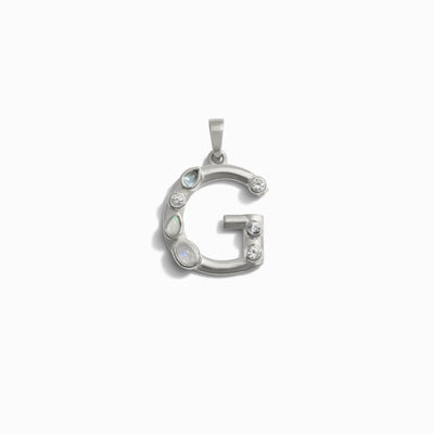 Awe Inspired's Gemstone Initial Pendant features a silver 'G' adorned with six bezel-set gemstones, artfully arranged along its curves.