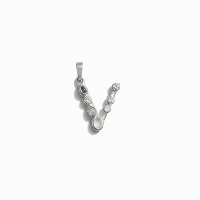 The Awe Inspired Gemstone Initial Pendant is a silver "V" shaped pendant adorned with multiple bezel-set round gemstones, ideal for those who love personalized jewelry.