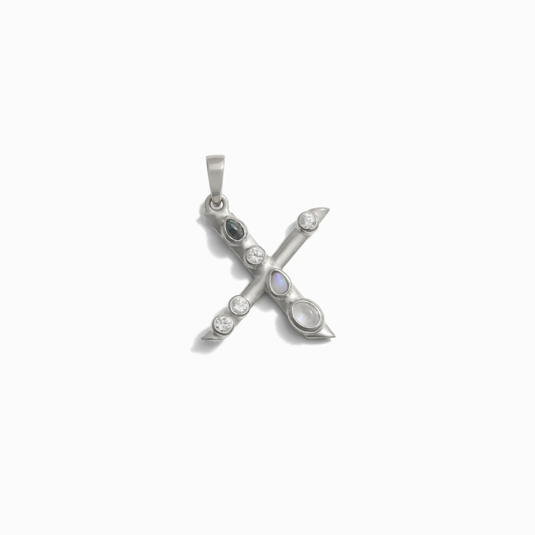 Awe Inspired's Gemstone Initial Pendant features a silver 'X' adorned with bezel set gemstones.