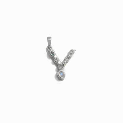 Awe Inspired's Gemstone Initial Pendant features a silver "Y" adorned with multiple bezel-set gemstones along its structure.