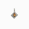 The Aura Pendant by Awe Inspired is a silver pendant with a diamond shape, featuring an amber-colored, marquise-cut stone in the center, set against a textured background. This stunning piece is designed to harmonize your aura and balance your chakras.