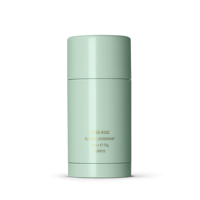 A cylindrical green deodorant stick labeled "Third Rose Deodorant by Corpus, 2.6oz 75g, Corpus" uses a water-based formula that is gentle on underarms while providing long-lasting protection.