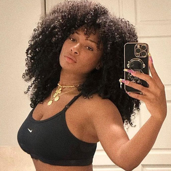 Megan Thee Stallion wearing a layered necklace set featuring Aphrodite Goddess coin necklace by Awe Inspired in Gold